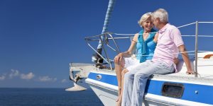 Elderly couple together on luxury boat, enjoying retirement