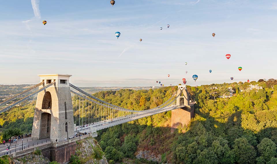Clifton Suspension Bridge with hot air balloons in the sky above